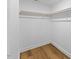 Walk-in closet featuring wood floor and shelving at 508 N Charles St, Mebane, NC 27302