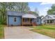 Charming blue home featuring a cozy front porch and well-manicured lawn at 508 N Charles St, Mebane, NC 27302