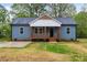 Charming blue home with a cozy front porch and well-maintained lawn at 508 N Charles St, Mebane, NC 27302
