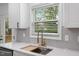 Close-up of a kitchen sink with modern faucet and bright natural lighting at 508 N Charles St, Mebane, NC 27302