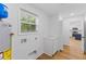 Laundry room has a window, storage, new flooring and a view to the kitchen at 508 N Charles St, Mebane, NC 27302