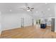 Open-concept living room featuring modern lighting and beautiful wood floors at 508 N Charles St, Mebane, NC 27302