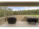 Covered back porch with grill offering serene views of the expansive backyard at 52 Sagebrook Ct, Zebulon, NC 27597