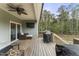 Spacious back porch with grill and outdoor seating overlooking wooded backyard at 52 Sagebrook Ct, Zebulon, NC 27597