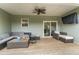 Inviting back porch with comfortable seating, a ceiling fan, and a mounted television at 52 Sagebrook Ct, Zebulon, NC 27597