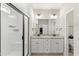 Modern bathroom boasts double vanity, granite counters and a glass shower at 52 Sagebrook Ct, Zebulon, NC 27597