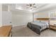 Bright primary bedroom boasts a tray ceiling, carpet floors, and modern furniture at 52 Sagebrook Ct, Zebulon, NC 27597