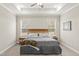 Neutral bedroom features a tray ceiling, ceiling fan, and two bright windows at 52 Sagebrook Ct, Zebulon, NC 27597