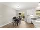 Kitchen dining area with dark wood table and chairs, and backyard access at 52 Sagebrook Ct, Zebulon, NC 27597