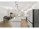 Modern kitchen showcasing white cabinets, a kitchen island, and stainless steel appliances at 52 Sagebrook Ct, Zebulon, NC 27597