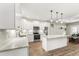 Modern kitchen showcasing white cabinets, a kitchen island, and stainless steel appliances at 52 Sagebrook Ct, Zebulon, NC 27597