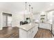 Bright kitchen features white cabinets, granite countertops, and a large kitchen island at 52 Sagebrook Ct, Zebulon, NC 27597