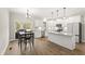 Eat-in kitchen boasts stainless appliances, custom cabinetry, and backyard access at 52 Sagebrook Ct, Zebulon, NC 27597