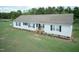 An elevated view shows a well-maintained ranch home with a spacious yard and mature trees at 660 Our Way, Linden, NC 28356