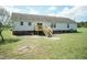 Backyard of home with deck and grass lawn at 660 Our Way, Linden, NC 28356