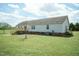 Backyard of home with deck, stairs, and grass lawn at 660 Our Way, Linden, NC 28356