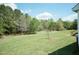 Expansive backyard featuring well-maintained lawn and a backdrop of mature trees at 660 Our Way, Linden, NC 28356