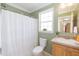 Bright bathroom featuring a shower with curtain, toilet, and a sink at 660 Our Way, Linden, NC 28356