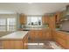 Bright kitchen features wood cabinets, stainless steel appliances, and a large window with a view at 660 Our Way, Linden, NC 28356