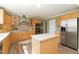 Charming kitchen featuring stainless appliances, wood cabinets, island and tile backsplash at 660 Our Way, Linden, NC 28356