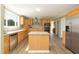 This kitchen boasts wood cabinets, stainless steel appliances, and a center island with a tile countertop at 660 Our Way, Linden, NC 28356