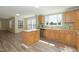 An open-concept kitchen featuring wood cabinets, stainless steel appliances, and a large island at 660 Our Way, Linden, NC 28356