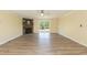 Spacious living room with wood-look floors, a stone fireplace, and sliding glass doors to the deck at 660 Our Way, Linden, NC 28356