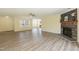 Open-concept living area with wood-look flooring, a fireplace, and abundant natural light at 660 Our Way, Linden, NC 28356
