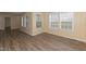 Bright living area with wood-look floors, large windows, and views into the kitchen at 660 Our Way, Linden, NC 28356