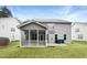 Spacious backyard with a screened porch perfect for outdoor living and entertaining, set against a lush green lawn at 7 Moonbeam Ct, Durham, NC 27712