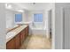 Bright bathroom featuring double vanity, soaking tub with tile surround, and a separate shower at 7 Moonbeam Ct, Durham, NC 27712