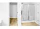 Bathroom with glass-door shower next to open door leading to closet at 7 Moonbeam Ct, Durham, NC 27712