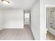 View of a bedroom that leads to a hallway and the main bathroom at 7 Moonbeam Ct, Durham, NC 27712