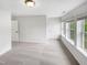 Spacious bedroom with three large windows, carpet flooring, and white trim at 7 Moonbeam Ct, Durham, NC 27712