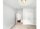 Neutral bedroom featuring a large closet and an ensuite bathroom at 7 Moonbeam Ct, Durham, NC 27712