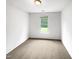 Cozy bedroom with carpet, a window overlooking a green yard, and neutral paint at 7 Moonbeam Ct, Durham, NC 27712