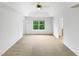 Large empty bedroom with neutral carpet and a large window with a backyard view at 7 Moonbeam Ct, Durham, NC 27712