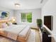 Comfortable bedroom featuring a plush bed, neutral decor, and a large window overlooking a serene outdoor view at 7 Moonbeam Ct, Durham, NC 27712