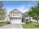 Charming two-story home features a two-car garage, well-maintained lawn, and inviting curb appeal on a sunny day at 7 Moonbeam Ct, Durham, NC 27712