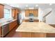 Open kitchen featuring granite countertops, stainless steel appliances, and a center island at 7 Moonbeam Ct, Durham, NC 27712
