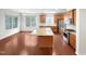 Open concept kitchen with stainless appliances, granite countertops, and center island with lots of natural light at 7 Moonbeam Ct, Durham, NC 27712