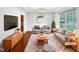 Bright living room with stylish furniture, neutral colors, and large windows offering a comfortable and inviting atmosphere at 7 Moonbeam Ct, Durham, NC 27712