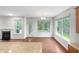 Cozy living room with a fireplace, hardwood floors, and views of the backyard at 7 Moonbeam Ct, Durham, NC 27712