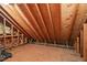 Spacious unfinished attic with exposed wooden beams and a plywood floor, ideal for storage or expansion at 7002 Old Trail Dr, Durham, NC 27712