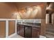 Cozy bar area with granite counters, wine cooler, and tiled backsplash, perfect for entertaining at 7002 Old Trail Dr, Durham, NC 27712