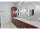 Bright bathroom features double sinks, granite countertops and modern lighting fixtures at 7002 Old Trail Dr, Durham, NC 27712