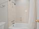 Clean bathroom showcasing a bathtub with a showerhead and a neutral-toned shower surround at 7002 Old Trail Dr, Durham, NC 27712