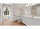 Bathroom featuring a toilet, vanity, and a window, offering both functionality and natural light at 7002 Old Trail Dr, Durham, NC 27712
