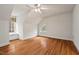 Bright bedroom with hardwood floors, angled ceilings, and windows with natural light at 7002 Old Trail Dr, Durham, NC 27712