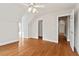 Bright bedroom features hardwood floors, neutral walls, ceiling fan and access to additional rooms at 7002 Old Trail Dr, Durham, NC 27712